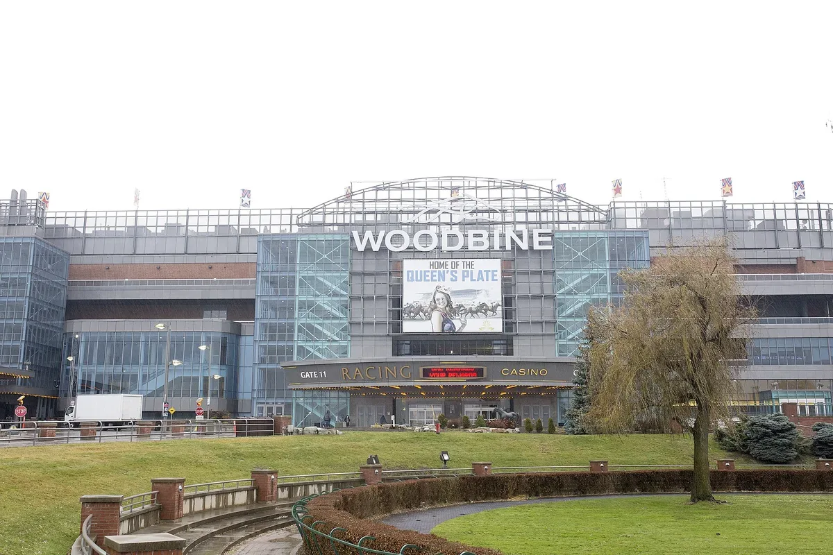 Front of the Woodbine racetrack grandstand in Toronto with racing and casino signs over the entrance